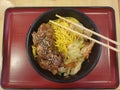 Chicken yakisoba or SÃÂsu yakissoba with vegetables in a black bowl with chopsticks Royalty Free Stock Photo